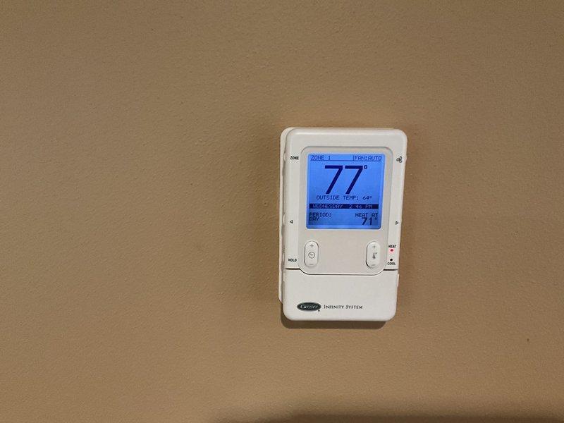 Conducted comprehensive HVAC system evaluation for furnace and air conditioning replacement estimate at residential property. Existing Carrier natural gas furnace located in basement was assessed following home inspection recommendation for replacement. Inspected internal components, ductwork configuration including triangular air distribution system, electrical connections, and condensate management system. Evaluated Carrier Infinity programmable thermostat system with multi-zone capabilities currently controlling HVAC operations. Documented equipment condition and discussed installation requirements with homeowner who requested premium installation service with scheduled arrival window and advance notification.