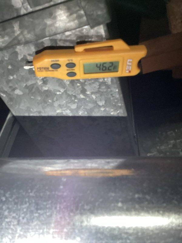 Completed HVAC tune-up service on residential system. Performed temperature and airflow measurements at supply ductwork, recording 64.5°F supply air temperature. Identified significant frost accumulation on evaporator coil and ductwork, indicating potential refrigerant charge issue, restricted airflow, or low ambient conditions affecting system performance. Documented measurements showing 462 CFM airflow at time of inspection.