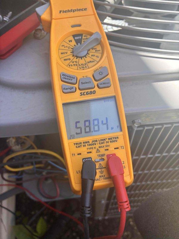 Completed comprehensive AC tune-up service including system performance diagnostics and electrical testing. Measured and recorded operating amperage at 58.84 amps using calibrated multimeter to verify compressor and system electrical performance within manufacturer specifications. Installed two new 14x20x1 air filters and cleared accumulated debris including leaves and organic matter from around the outdoor condensing unit to ensure proper airflow and system efficiency.