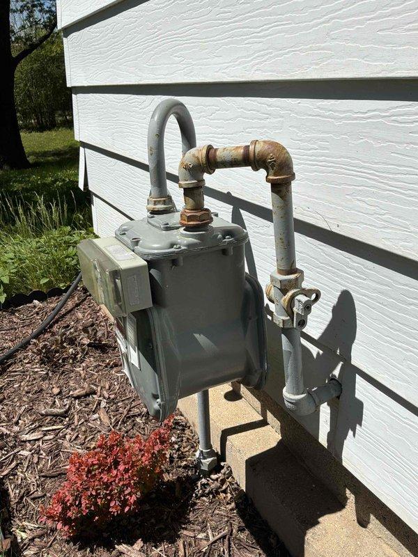 Responded to emergency service call for generator estimate at residential property. Assessed utility room installation area in basement with existing HVAC equipment and evaluated exterior gas meter connection point on building exterior. Documented current utility infrastructure including gas supply lines, electrical routing through ceiling joists, and available clearances for generator placement. Provided comprehensive estimate for standby generator installation including required electrical integration, gas line modifications, and proper outdoor positioning relative to existing meter assembly.