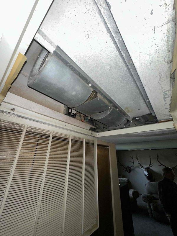 Completed on-site estimate for air handler replacement in residential property. Accessed ceiling cavity to inspect existing HVAC equipment, documenting current air handler configuration, ductwork connections, and installation conditions. Provided homeowner with replacement recommendations and specifications for new equipment installation.