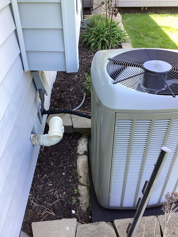 # HVAC Complete System Installation

## Work Performed

Completed full HVAC system replacement including new furnace, air conditioning condenser unit, F100 filter cabinet, and P200 thermostat. System was integrated with existing PVC venting infrastructure to minimize structural modifications while ensuring proper code compliance.

## Equipment Installed

Installed new residential air conditioning condenser unit on exterior concrete pad with proper clearances maintained from structure. Unit features top-discharge fan configuration with vertical louver panels for optimal airflow and heat rejection. Positioned unit on stable concrete foundation surrounded by mulch bed for drainage and aesthetic integration with existing landscaping.

Mounted new high-efficiency furnace in interior mechanical space with connections to existing ductwork distribution system. Integrated F100 media filter cabinet into return air plenum to provide enhanced air filtration and improved indoor air quality. Filter 