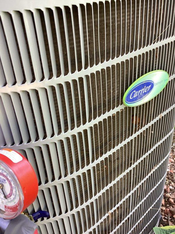 Performed comprehensive tune-up on Carrier air conditioning system. Connected manifold gauges to verify refrigerant pressures and system performance, confirmed proper operating pressures on both high and low sides. Applied coil cleaner to condenser unit and cleaned exterior fins to restore optimal heat transfer efficiency and airflow.