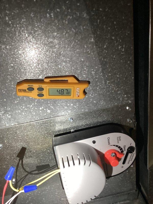 Completed HVAC system tune-up and performance verification. Measured supply air temperature at 48.7°F and return air temperature at 29.5°F, confirming proper system operation and adequate temperature differential. Inspected damper control mechanism, verified proper operation of open/closed positions, and confirmed electrical connections were secure with wire nuts properly installed.