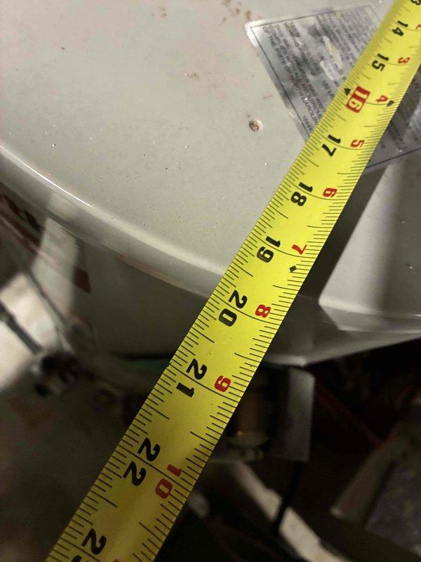 Conducted on-site assessment of existing natural gas water heater in residential utility room for replacement estimate. Documented current equipment configuration including water heater installation, venting system, and surrounding HVAC components. Measured and photographed equipment dimensions and clearances to determine proper replacement unit specifications and installation requirements.