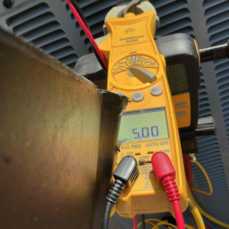 Performed routine maintenance and tune-up on residential air conditioning system. Conducted electrical diagnostics using clamp meter to verify proper amperage draw and system performance at outdoor condensing unit. All components inspected and found operating within normal parameters.