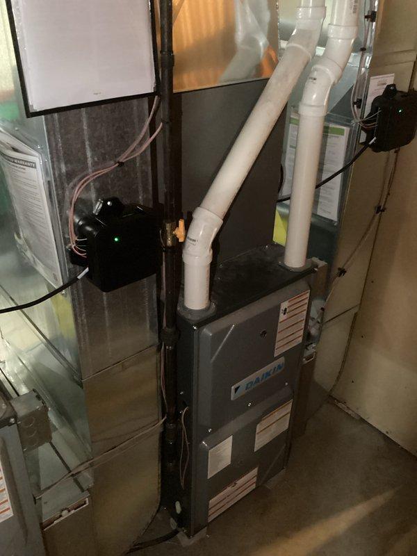 Completed installation of two new Daikin HVAC systems in residential basement, including air handler units mounted on concrete block bases with proper ductwork transitions and venting. Both units were installed side by side to serve separate zones, with all electrical connections, PVC exhaust/intake venting, and sheet metal ductwork professionally routed and secured per manufacturer specifications.