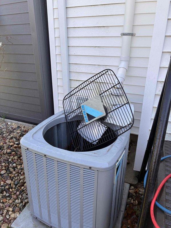 Completed comprehensive furnace and air conditioning tune-up maintenance service. Performed full system inspection of outdoor condensing unit, including removal of fan guard to access and clean internal components, checked refrigerant levels, inspected electrical connections, and verified proper operation of both heating and cooling systems.
