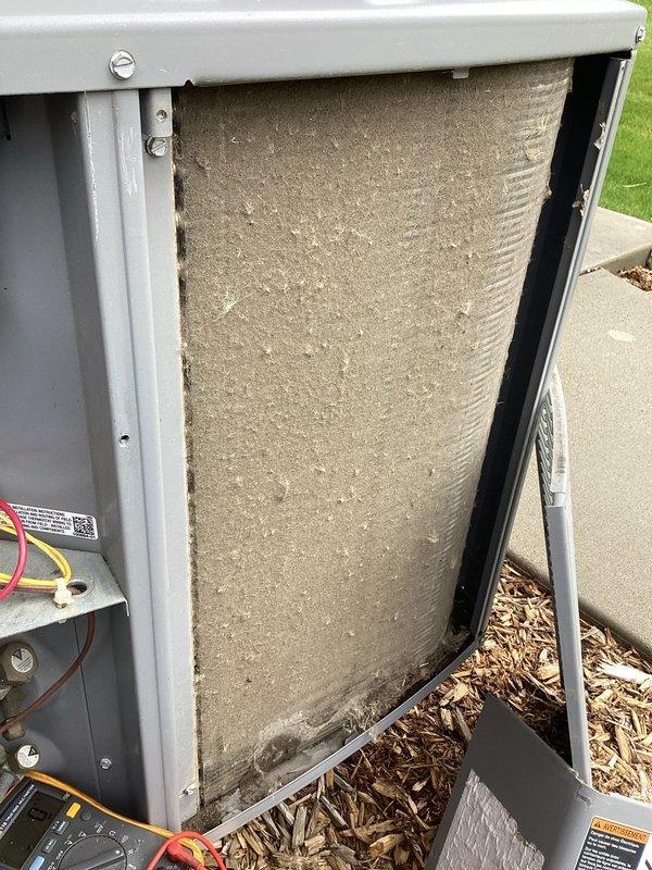 Completed standard AC tune-up maintenance on residential air conditioning system. Inspected electrical connections, capacitor, and wiring within control panel; all components found to be in acceptable working condition. Noted heavily soiled air filter requiring replacement and recommended immediate filter change to maintain proper airflow and system efficiency.