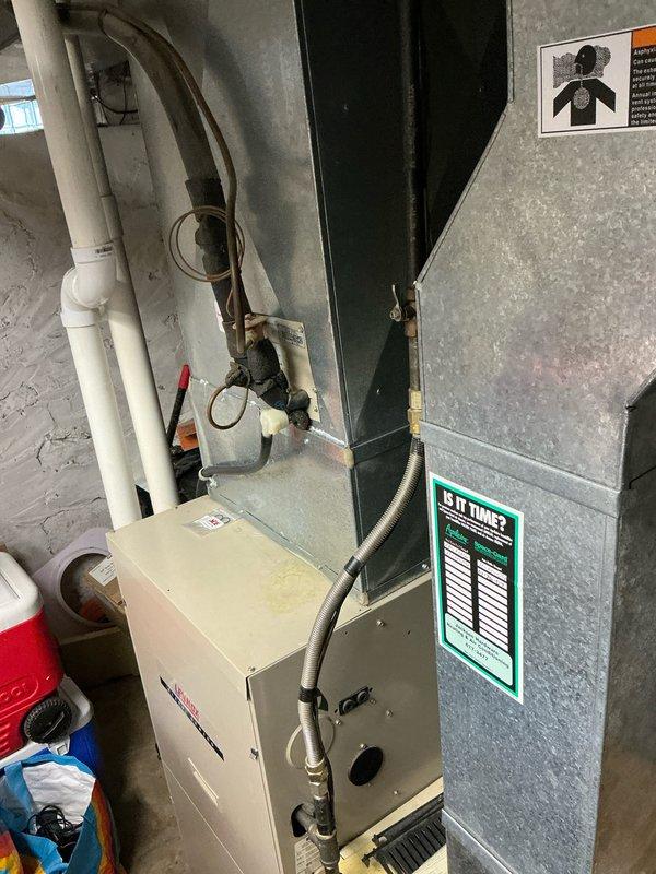 Responded to emergency service call for non-functional air conditioning system requiring complete replacement. Upon assessment, determined existing AC unit had failed beyond economical repair and provided comprehensive estimate for full system replacement including new air handler, ductwork modifications, refrigerant lines, condensate drainage system, and electrical connections. Documented existing basement installation showing furnace, air handler, PVC venting and drainage piping, and ductwork configuration with insulated refrigerant lines to support replacement specifications and ensure proper system sizing for residential application.