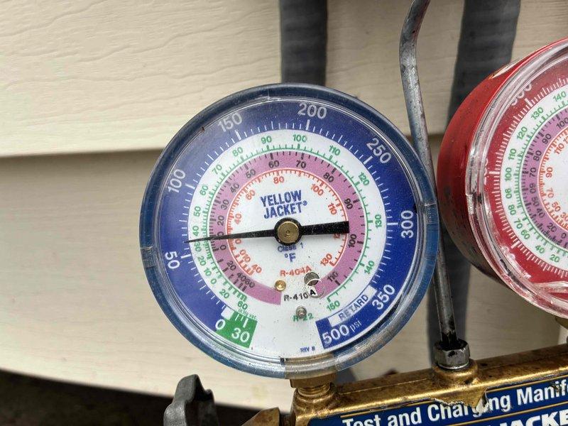 Responded to no cooling complaint on aging residential air conditioning system. Upon arrival, performed diagnostic evaluation of outdoor condenser unit showing signs of weathering and age-related deterioration. Connected manifold gauge set to measure system pressures and assess refrigerant charge levels. Gauges indicated abnormal operating pressures consistent with potential refrigerant loss or compressor issues. Advised customer that unit has reached end of serviceable life expectancy and temporary repair may not be feasible or cost-effective. Customer acknowledged plans to proceed with full system replacement and requested diagnostic findings to inform replacement decision.