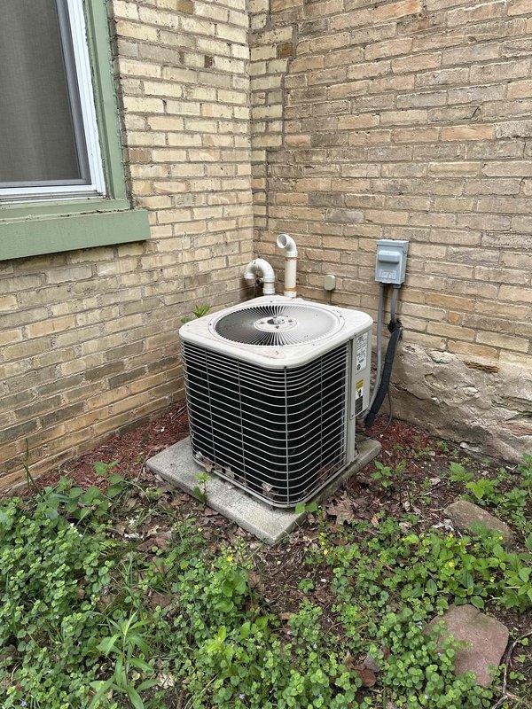 Conducted comprehensive estimate for complete HVAC system replacement at residential property. Evaluated existing boiler-based heating system with air handler for conversion to central air conditioning with new ductwork installation. Assessed basement mechanical room containing current equipment including aged HVAC unit, existing copper piping infrastructure, and electrical panel configuration. Inspected exterior location for outdoor condensing unit placement against brick exterior wall with existing concrete pad and electrical disconnect box. Provided detailed replacement specifications for transitioning from boiler system to complete forced-air heating and cooling system with appropriate ductwork design for optimal airflow distribution throughout residence.