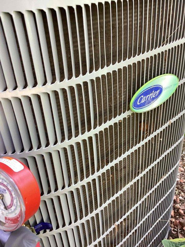 Responded to no cooling call on Carrier air conditioning system. Upon inspection, found system low on refrigerant due to leaking Schrader valve cores at service ports. Replaced both valve cores with new brass components and recharged system to manufacturer specifications. Applied coil cleaner to outdoor condenser unit and cleaned debris from fins to restore proper airflow and heat transfer. System tested and confirmed cooling operation restored with proper temperatures and pressures.