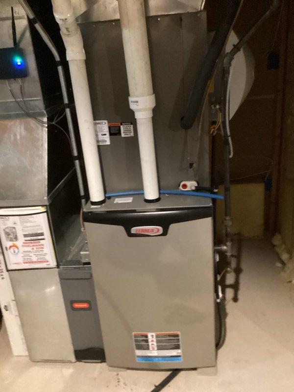 Responded to no cooling complaint on residential HVAC system. Upon arrival, performed diagnostic inspection of Lennox furnace and air handler unit in basement mechanical room. Inspected indoor equipment components, ductwork connections, and condensate drainage system. Examined blower motor assembly and electrical connections through access panel, noting accumulated dust and debris within the unit compartment. Verified system operation and identified issues preventing adequate cooling performance. Equipment showed signs of normal operational wear with dust accumulation on internal components affecting airflow efficiency.