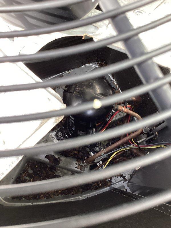 Responded to no cooling complaint on residential HVAC system. Upon arrival, performed diagnostic inspection of Lennox furnace and air handler unit in basement mechanical room. Inspected indoor equipment components, ductwork connections, and condensate drainage system. Examined blower motor assembly and electrical connections through access panel, noting accumulated dust and debris within the unit compartment. Verified system operation and identified issues preventing adequate cooling performance. Equipment showed signs of normal operational wear with dust accumulation on internal components affecting airflow efficiency.
