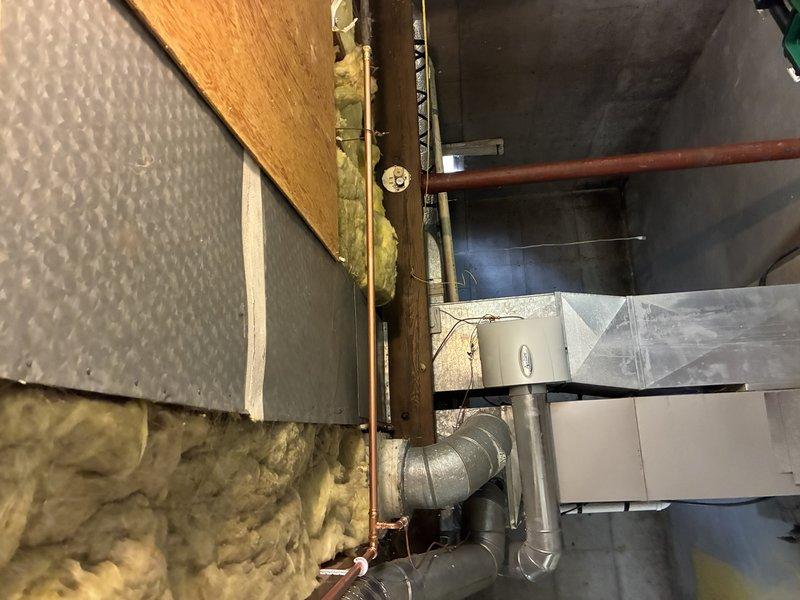 Disconnected and capped water supply lines running to existing shower in preparation for demolition. Capped shower drain to prevent sewer gas entry during removal phase. Installation will resume once existing shower unit is removed and new framing is completed to accommodate customer-supplied shower valve and drain assembly.