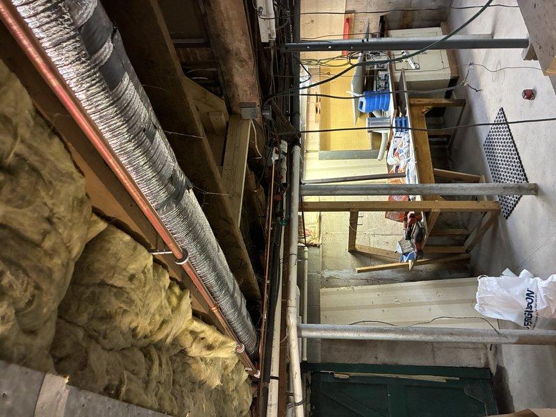 Disconnected and capped water supply lines running to existing shower in preparation for demolition. Capped shower drain to prevent sewer gas entry during removal phase. Installation will resume once existing shower unit is removed and new framing is completed to accommodate customer-supplied shower valve and drain assembly.