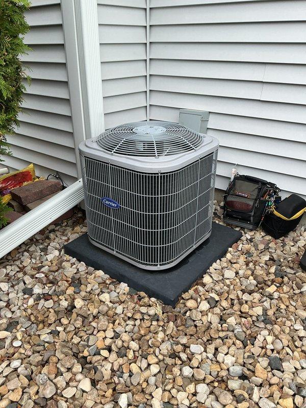 Completed preventive maintenance cooling visit on Carrier residential air conditioning system as part of prepaid membership agreement. Inspected outdoor condensing unit positioned on rubber pad with proper gravel drainage, confirmed unit integrity with no visible damage to protective grille or coil fins. Evaluated indoor furnace and ductwork connections, verified proper gas line installation and venting configuration. System operating within normal parameters with all components in good working condition.