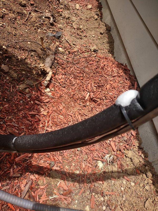 Responded to no cooling call and found ice buildup on the evaporator coil. Instructed customer to turn off system to allow ice to thaw. Air handler located in attic, outdoor condensing unit inspected and photographed showing normal exterior condition with standard condensate drainage components.