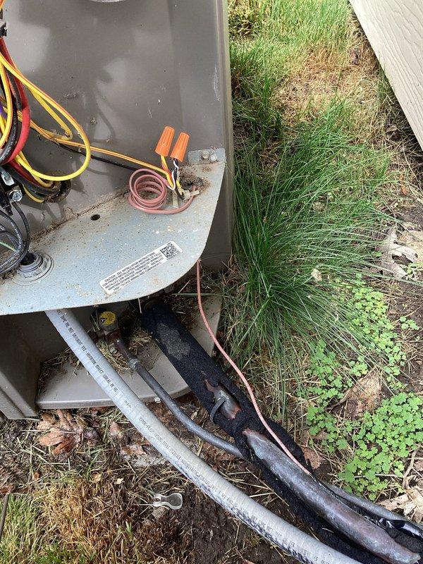 Responded to no cooling complaint with evaporator coil icing up on 10+ year old system. Upon arrival, confirmed unit was shut off as instructed to allow ice to thaw. Inspected outdoor condensing unit and found system showing signs of age with weathered components, though electrical connections at contactor appeared intact with proper wire terminations. Refrigerant lines and insulation showed normal wear consistent with system age, and condenser cabinet maintained structural integrity on concrete pad.