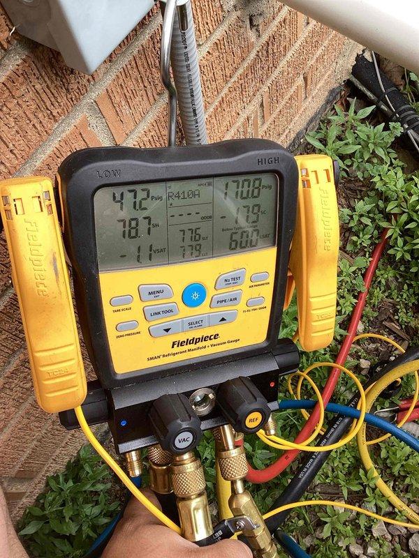 Responded to no cooling complaint on duplex unit. Upon arrival, performed diagnostic testing using digital manifold gauges and found system operating on R410A refrigerant with abnormal pressures (472 PSIG high side, 77 PSIG low side). Utilized temperature clamps to verify superheat and subcooling readings. Unit showed signs of neglected maintenance with debris accumulation in condenser section and dirty coil fins. Confirmed refrigerant charge deficiency as primary cause of no cooling condition. As requested, checked pressures on adjacent duplex unit to verify system integrity on other side of property.