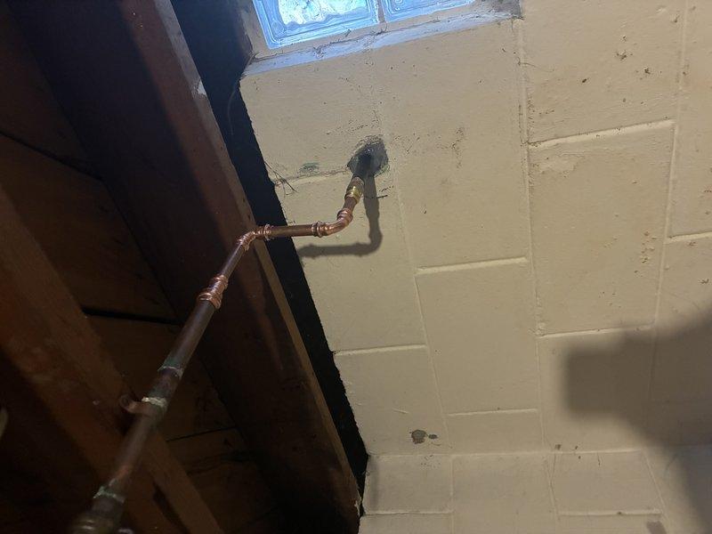 Installed new frost-free hose bib on exterior brick wall with copper supply line connection routed through basement utility area. Secured copper piping to interior concrete block wall with proper support brackets, completed soldered joints, and verified system for proper operation and leak-free performance.