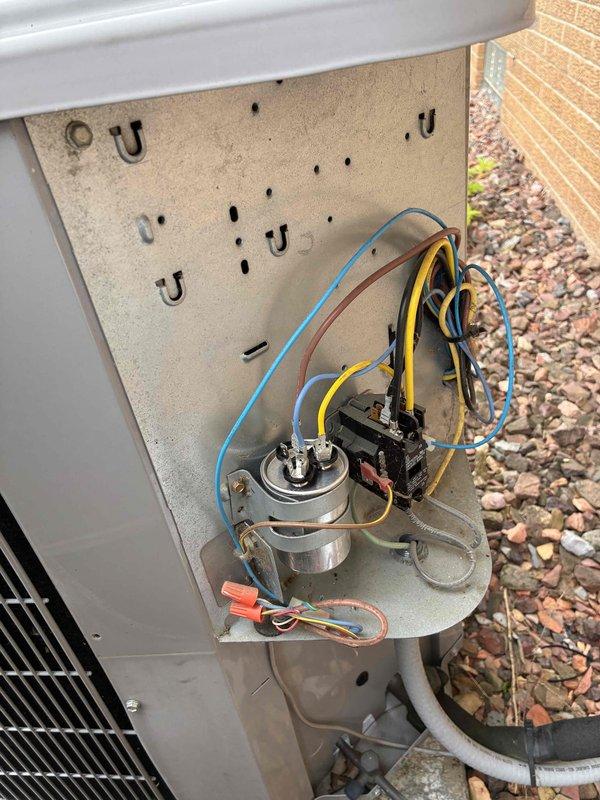 Responded to no cooling complaint on residential air conditioning system. Upon arrival, accessed outdoor condenser unit electrical compartment and inspected internal components including contactor, capacitor, and associated wiring connections. Connected refrigerant manifold gauge set to service ports and measured system pressures to diagnose refrigerant charge and compressor operation. Visual inspection revealed all electrical connections secure with proper wire nutting in place. Condenser coil showed normal condition with no visible blockage or damage. Unit operational at time of service with normal pressure readings observed. Customer reported neighbor mentioned unusual noises, but no abnormal sounds detected during diagnostic evaluation. System restored to proper cooling operation.