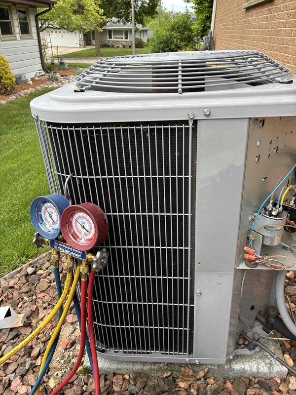 Responded to no cooling complaint on residential air conditioning system. Upon arrival, accessed outdoor condenser unit electrical compartment and inspected internal components including contactor, capacitor, and associated wiring connections. Connected refrigerant manifold gauge set to service ports and measured system pressures to diagnose refrigerant charge and compressor operation. Visual inspection revealed all electrical connections secure with proper wire nutting in place. Condenser coil showed normal condition with no visible blockage or damage. Unit operational at time of service with normal pressure readings observed. Customer reported neighbor mentioned unusual noises, but no abnormal sounds detected during diagnostic evaluation. System restored to proper cooling operation.