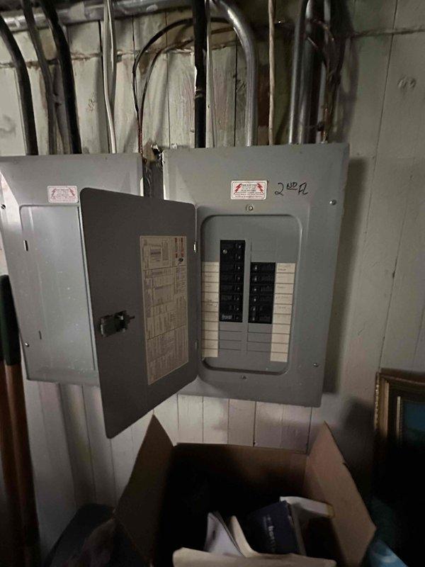 Completed estimate for adding air conditioning system to one unit of a duplex property equipped with existing older forced air furnaces. Assessed basement mechanical area containing current HVAC equipment and ductwork infrastructure, evaluated electrical service capacity via inspection of second floor circuit panel, and documented existing duct system configuration to determine AC integration requirements for upcoming summer installation.