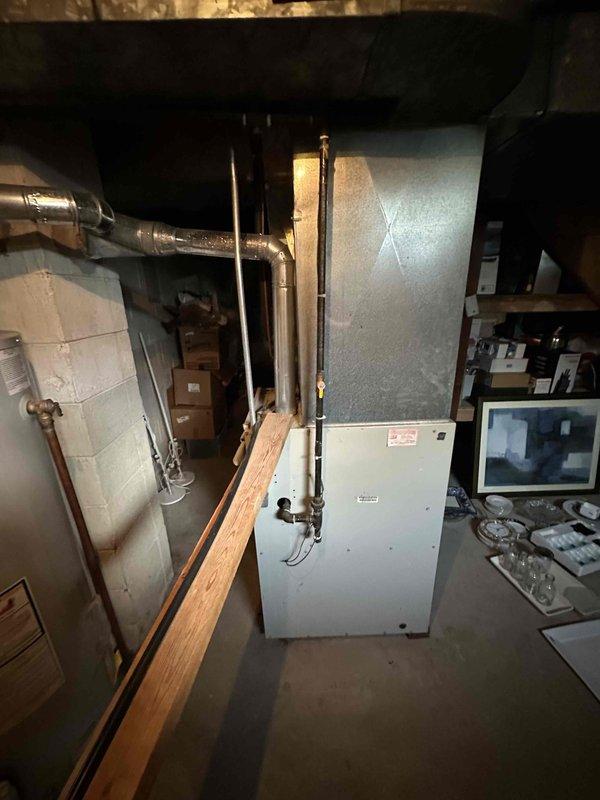 Completed estimate for residential furnace and air conditioning system replacement in basement location. Assessed existing HVAC equipment, electrical panel capacity, ductwork configuration, and copper refrigerant line routing. Documented current mechanical room layout including air handler unit, metallic plenum assembly, and associated plumbing infrastructure. Photographed electrical service panel and existing heating/cooling equipment to provide accurate replacement specifications and ensure proper system sizing for the property.