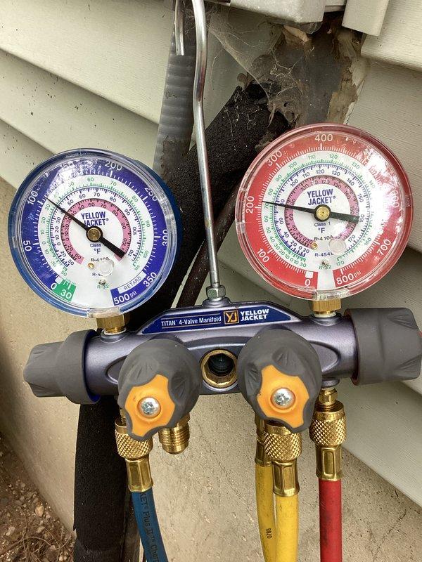 Performed comprehensive air conditioning tune-up service utilizing Yellow Jacket TITAN 4-valve manifold gauge set to measure system pressures and verify proper refrigerant charge levels. System diagnostics showed readings of 609 PSI, and all refrigerant lines, electrical connections, and service ports were inspected to ensure optimal performance and system efficiency.