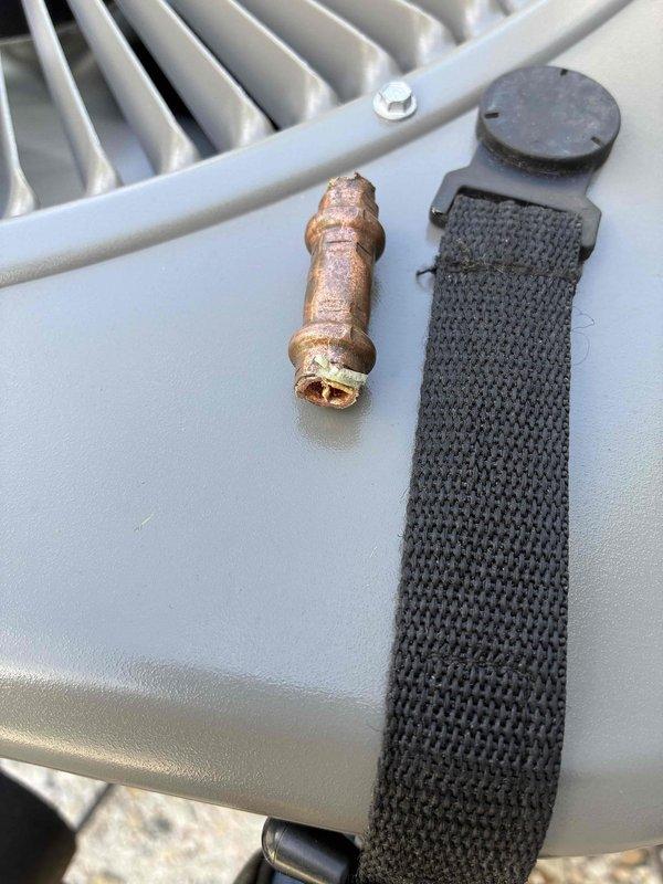 Responded to no-cooling call on recently installed AC unit. Upon arrival, performed diagnostic inspection and discovered severely corroded service valve and compromised refrigerant line connections. Replaced defective brass fittings, repaired copper line connections, and verified system pressures. Unit tested successfully and returned to normal operation.