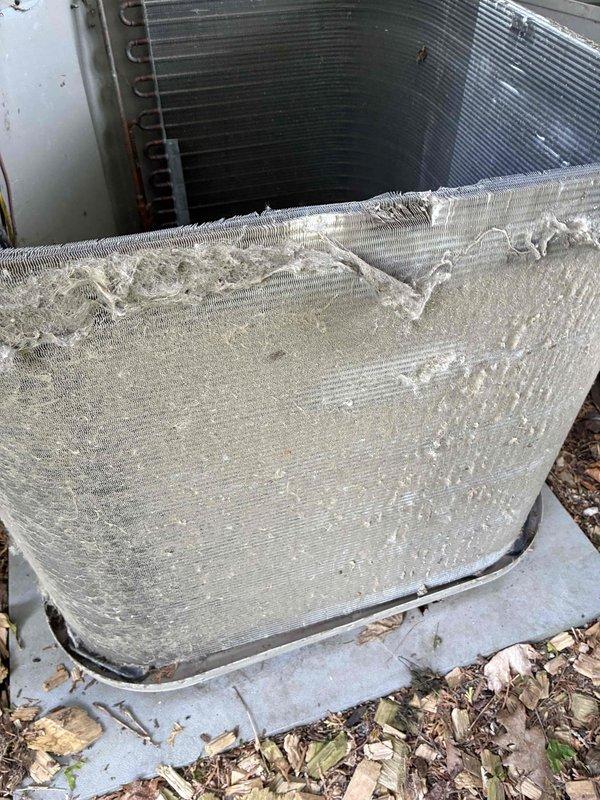 Completed comprehensive furnace and air conditioning tune-up service at residential property. Upon inspection, discovered significant frost and ice accumulation on the outdoor AC unit's evaporator coil, indicating potential refrigerant flow restriction, low charge, or airflow issues that require monitoring. Verified thermostat operation showing Honeywell ProSeries digital unit functioning properly in heat mode with temporary hold setting at 69°F. Noted debris accumulation around outdoor unit base that should be cleared to maintain proper airflow and system efficiency.