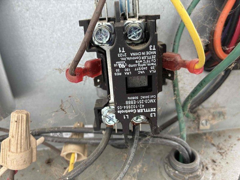 Completed comprehensive AC tune-up on residential outdoor condensing unit, including inspection of ZETTLER Controls contactor (model 42-102864-06), verification of all electrical connections and terminal tightness, and visual assessment of refrigerant line set routing and exterior unit condition. All components found operating within normal parameters with secure wire connections at contactor terminals and proper unit placement on concrete pad with adequate clearances.