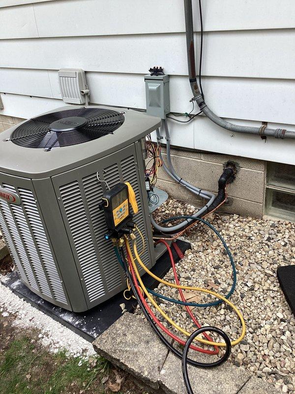 Completed installation of Lennox air handler system with 3-man crew at residential garage location (code 6076). Unit was properly positioned on concrete pad with gravel base, refrigerant lines and electrical conduit secured to exterior wall, and system charged and tested to manufacturer specifications.