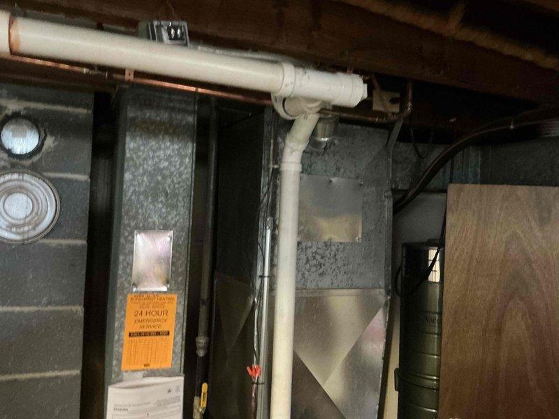 Responded to a Costco lead for a non-operational air conditioning system requiring replacement estimate. Upon arrival at the property, assessed the existing HVAC system located in the basement, which includes a natural gas furnace and air conditioning unit. Documented the current equipment configuration, including the dark metal furnace cabinet with associated PVC condensate drainage lines and copper refrigerant piping secured to the floor joists. Reviewed the electrical service panel to verify circuit capacity and breaker configuration for the existing heating and cooling equipment. Provided comprehensive replacement estimate for new air conditioning system to address the failed unit.