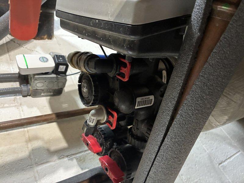 Completed on-site estimate for replacement of existing iron curtain water treatment system. Inspected current installation including control valve assembly with electronic controller, insulated media tank, and associated plumbing connections. Documented equipment condition and provided replacement recommendations for upgraded water treatment solution to address iron removal needs.