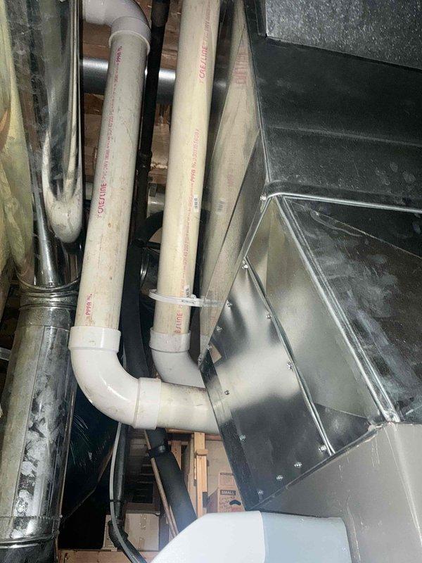 Completed comprehensive HVAC system replacement estimate for residential air conditioning unit. Performed detailed measurements and created technical diagram of existing ductwork configuration, including supply and return plenum dimensions, with specifications for custom panel work, line set routing, and supplemental coil installation. Documented current attic installation showing PVC condensate lines, sheet metal ductwork, and existing equipment layout to provide accurate replacement system specifications.