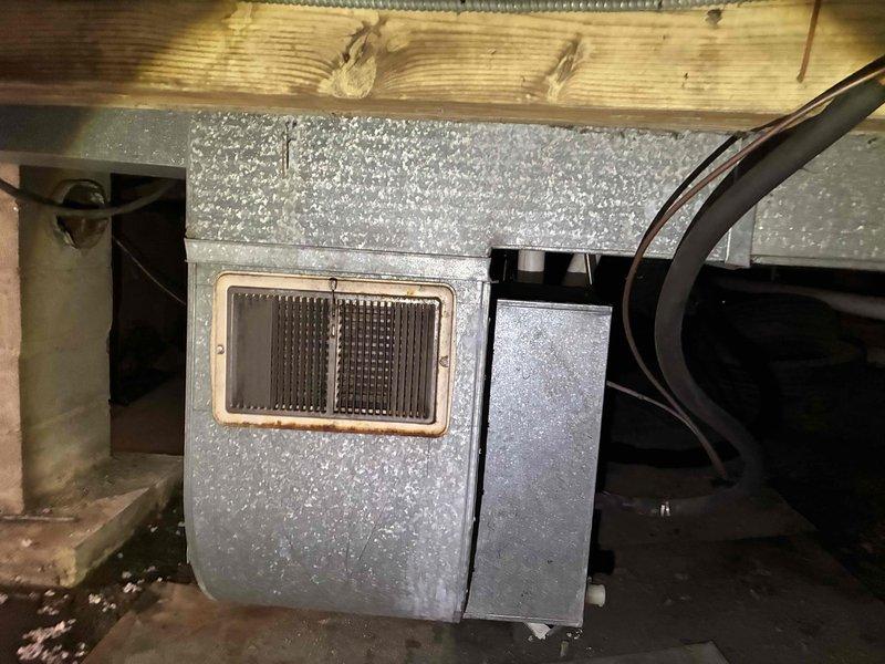 Completed estimate for replacement of 38-year-old air conditioning system located in crawl space accessible from walk-down basement. Unit showed significant deterioration with heavy rust and corrosion on metal components, indicating extended exposure to moisture and age-related degradation. Documented existing equipment condition through photos and provided replacement recommendations for aging HVAC system that has exceeded its typical service life.