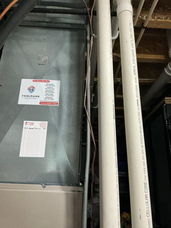 Completed comprehensive AC and furnace tune-up on residential HVAC system located in basement utility area. Performed standard maintenance procedures including inspection of mechanical components, verification of proper operation, and testing of system parameters using diagnostic probes. All equipment found to be functioning within normal specifications.
