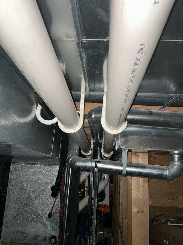 Responded to emergency service call for 19-year-old air conditioning system found to be low on R22 refrigerant. Evaluated existing HVAC equipment and mechanical systems, documented current piping configuration including PVC condensate lines and insulated refrigerant lines, and assessed overall system condition to provide comprehensive replacement estimate for aging unit that has reached end of serviceable life.