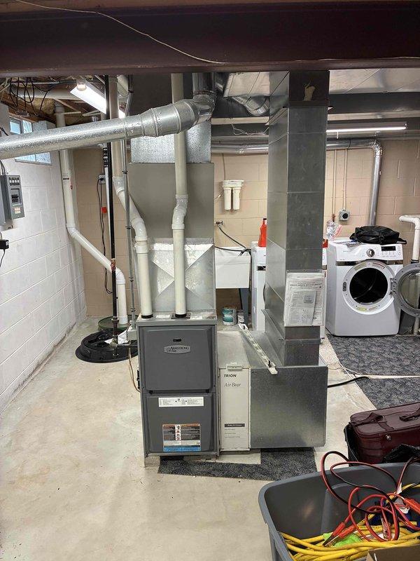 Conducted estimate for complete HVAC system replacement in residential basement location. Evaluated existing furnace unit with extensive ductwork system and determined equipment failure requiring full replacement. Documented current installation including vertical furnace configuration, associated ductwork distribution, PVC condensate drainage system, and electrical connections. Assessed basement mechanical room layout and clearances for new equipment installation. Photographed existing system components and infrastructure to develop comprehensive replacement proposal for non-operational heating and cooling equipment.
