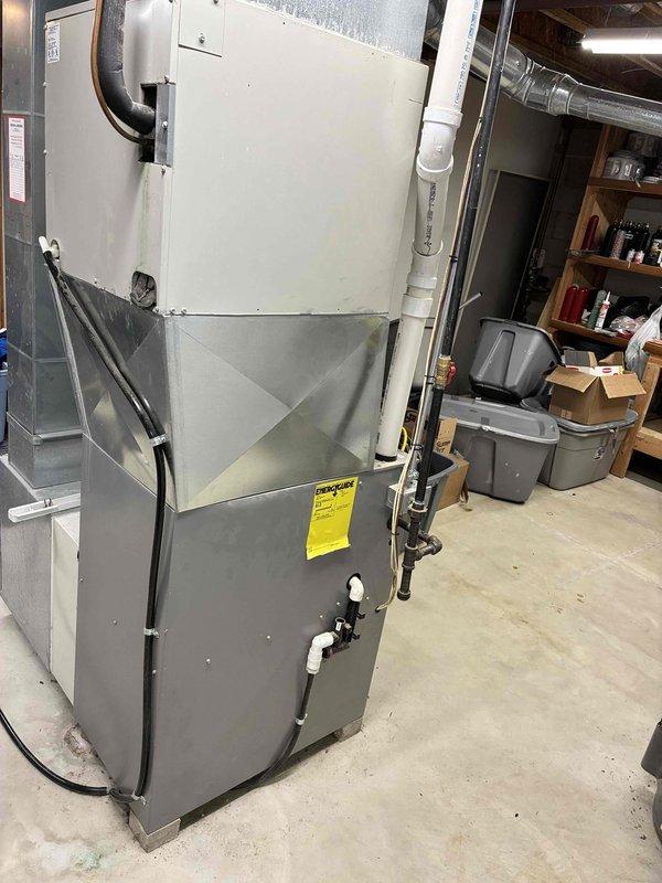 Conducted estimate for complete HVAC system replacement in residential basement location. Evaluated existing furnace unit with extensive ductwork system and determined equipment failure requiring full replacement. Documented current installation including vertical furnace configuration, associated ductwork distribution, PVC condensate drainage system, and electrical connections. Assessed basement mechanical room layout and clearances for new equipment installation. Photographed existing system components and infrastructure to develop comprehensive replacement proposal for non-operational heating and cooling equipment.