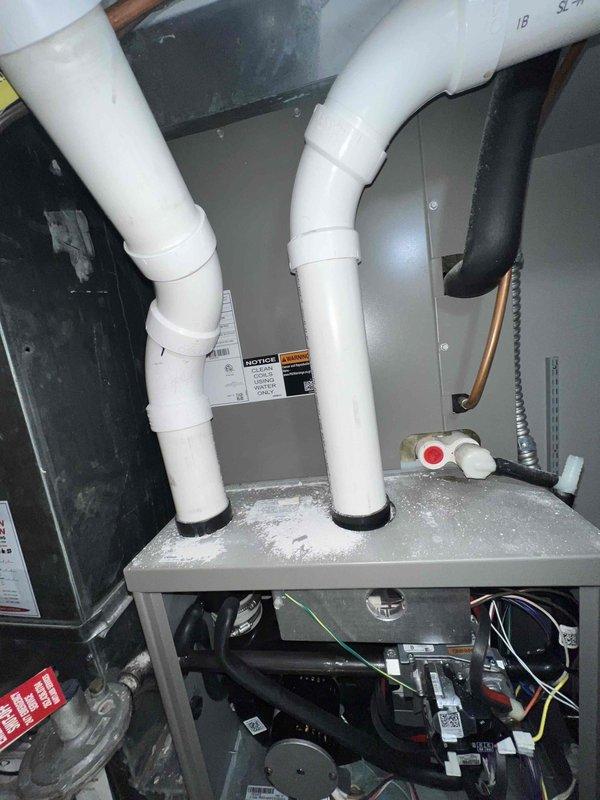 Responded to service call for upstairs HVAC unit inspection due to water heater leaking in proximity to equipment. Performed comprehensive inspection of air handler system located in attic space to assess potential water damage from recurring water heater leak. Inspected control board, wiring connections, and electrical components for moisture intrusion and corrosion. Observed visible water staining and moisture marks on interior base pan of air handler unit. Examined blower motor assembly, drain lines, and PVC condensate piping for proper operation and potential secondary water damage. Documented equipment condition with photographs showing control wiring, dehumidification components, and overall air handler installation. Recommended homeowner contact insurance provider regarding water damage assessment and potential equipment replacement or remediation due to ongoing water exposure from external source.