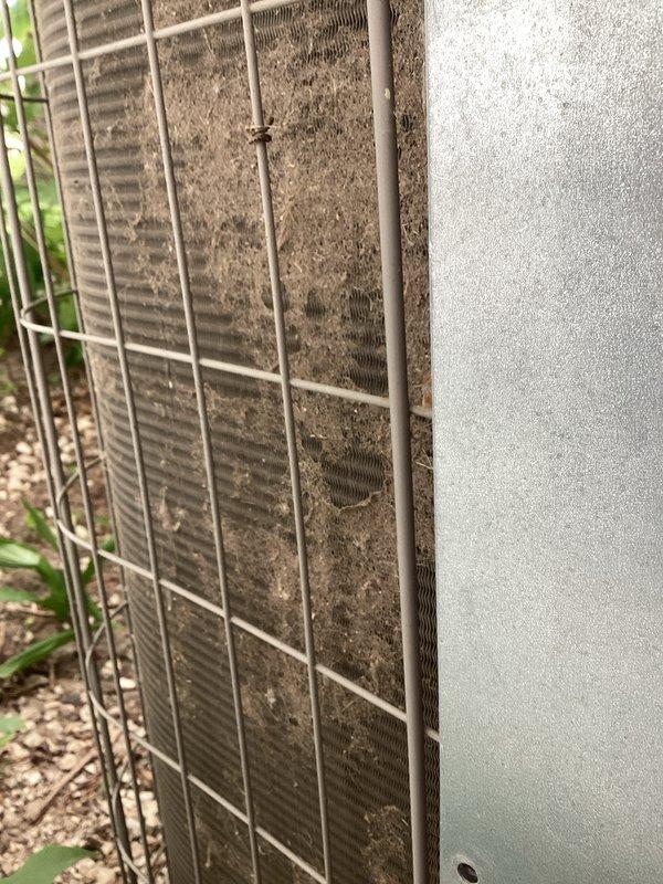 Performed comprehensive air conditioning tune-up on outdoor condensing unit. Upon arrival, found condenser coils heavily clogged with dirt, dust, and debris, significantly restricting airflow and reducing system efficiency. Cleaned condenser coils, inspected electrical components including capacitor and wiring connections, and documented equipment information for service records.