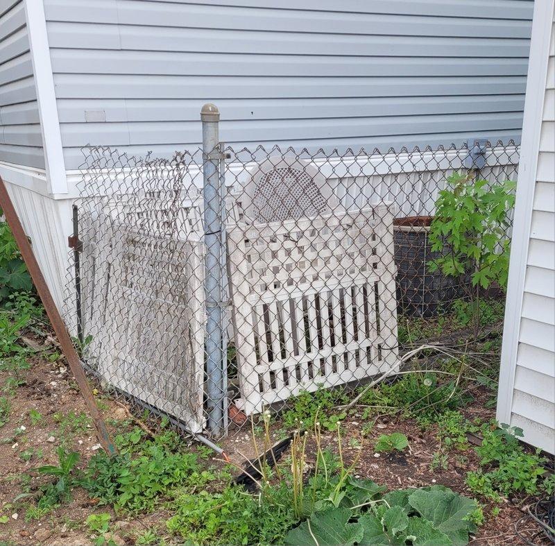Responded to no cooling call on residential air conditioning system over 10 years old. Upon arrival, found outdoor condenser unit showing significant age-related wear with darkened grille components and vegetation growth restricting airflow around the base. Unit requires preventive maintenance appointment to address accumulated debris, verify refrigerant charge, and assess overall system performance to restore proper cooling operation.