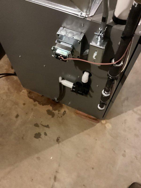 Completed full furnace and zoning system installation in basement utility area. Installed new air handler unit with copper refrigerant lines properly insulated and connected with appropriate fittings and valves. Ran PVC condensate drain line vertically from unit. Mounted all equipment securely to concrete floor with proper brackets and verified all plumbing connections meet code requirements. Installed zoning control components including electrical junction boxes and wiring harnesses on secondary unit. Routed black conduit lines along unit exterior and secured with mounting brackets. Connected all electrical components and verified proper operation of both heating unit and zoning controls. System tested and operational.