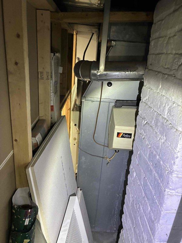 Conducted on-site assessment of existing furnace and air conditioning system located in basement mechanical room. Evaluated current HVAC equipment positioned in confined space between painted brick walls, documented equipment specifications, and provided estimate for complete furnace and AC replacement with natural gas furnace unit including necessary ductwork modifications.