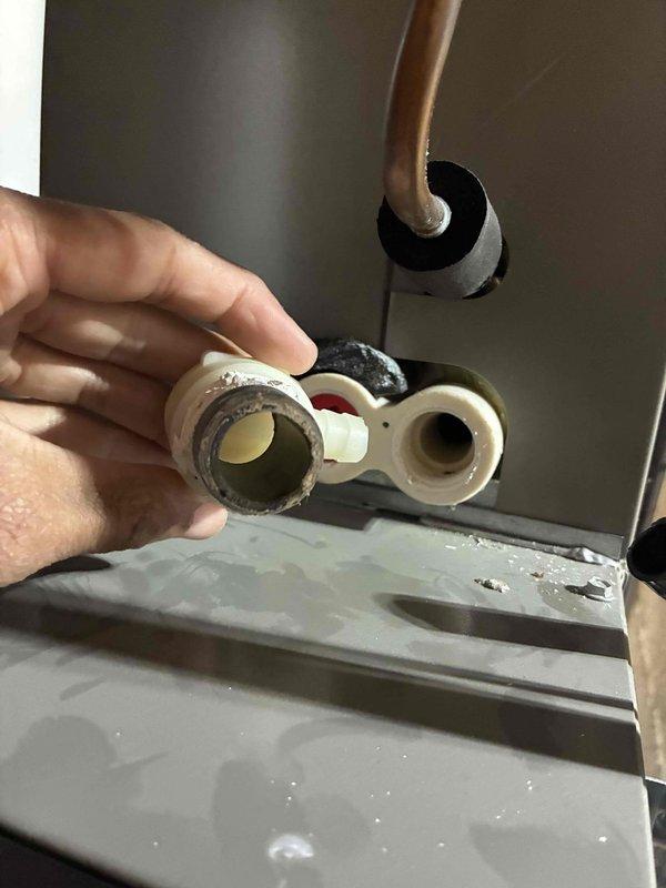 Completed rescheduled system start-up following previous cold weather delay. Verified refrigerant charge levels and measured system temperatures, confirming proper operation with suction line temperature reading at 51.9°F. Inspected refrigerant line connections and penetrations through cabinet structure, ensuring all fittings and seals were secure with no visible leaks or defects.
