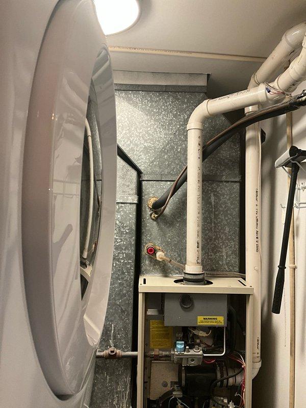 Conducted estimate for complete HVAC system replacement at condo unit with rooftop installation. Assessed existing furnace and air conditioning system, both located in interior utility closet, and determined AC unit non-operational. Documented current equipment configuration including water heater, furnace cabinet with internal components, ductwork, copper piping, PVC drainage lines, and electrical connections. Evaluated rooftop access requirements via interior hatch and determined crane lift will be necessary for equipment removal and installation due to rooftop unit configuration and building constraints. Photographed existing mechanical room layout showing furnace with open access panel revealing blower motor and gas burner assembly, galvanized ductwork, and confined utility space dimensions. Provided comprehensive replacement estimate for new furnace and air conditioning system with installation timeline coordinated for completion prior to late July occupancy requirement.